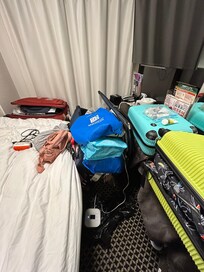 Could replace chair with stool so can open luggage. Take out room mirror and provide much needed shelving space. Reposition tv to bed corner and reduce size. Eliminate books and book holders