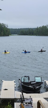 Three boys headed out on kayaks to catch fish for breakfast