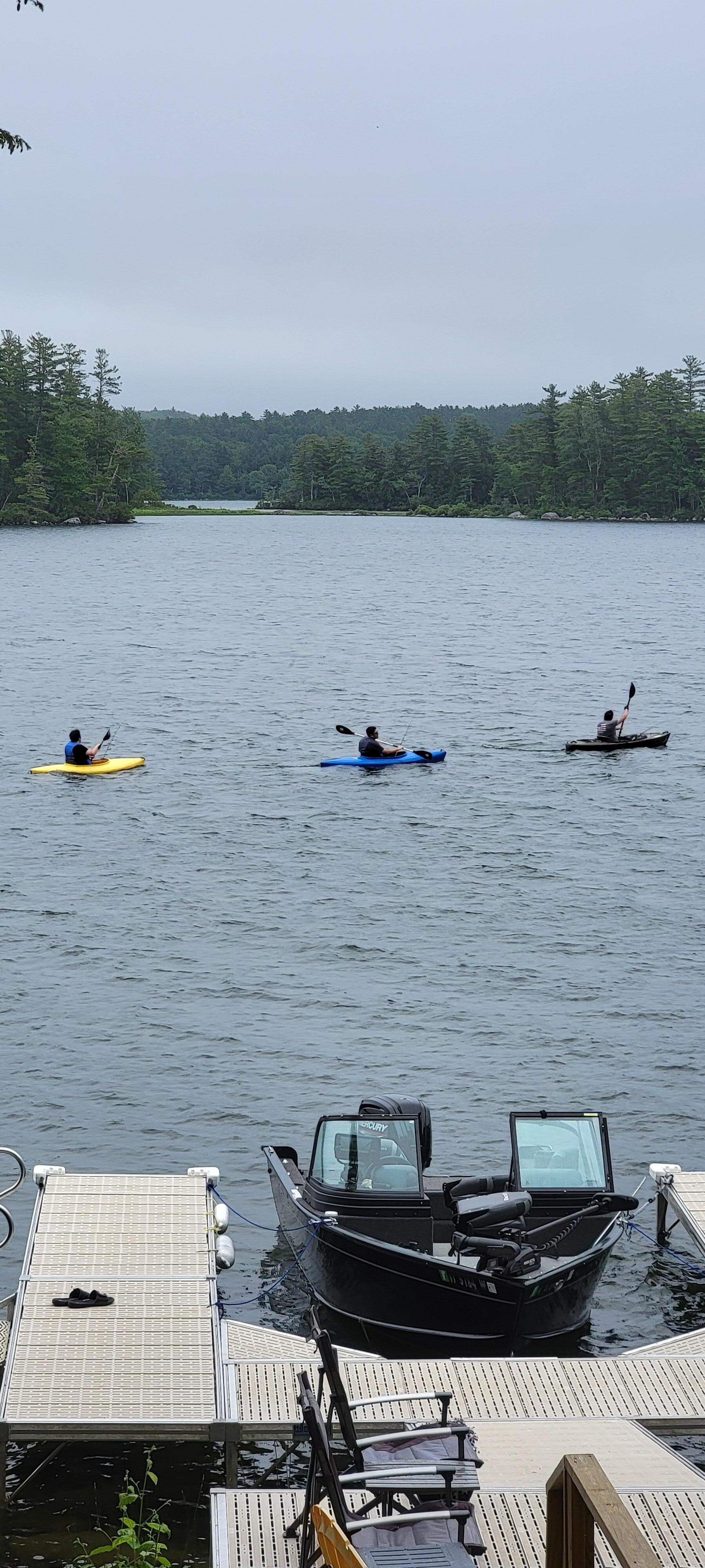 Three boys headed out on kayaks to catch fish for breakfast