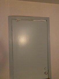 Adjoining door sealed with a towel and a sock