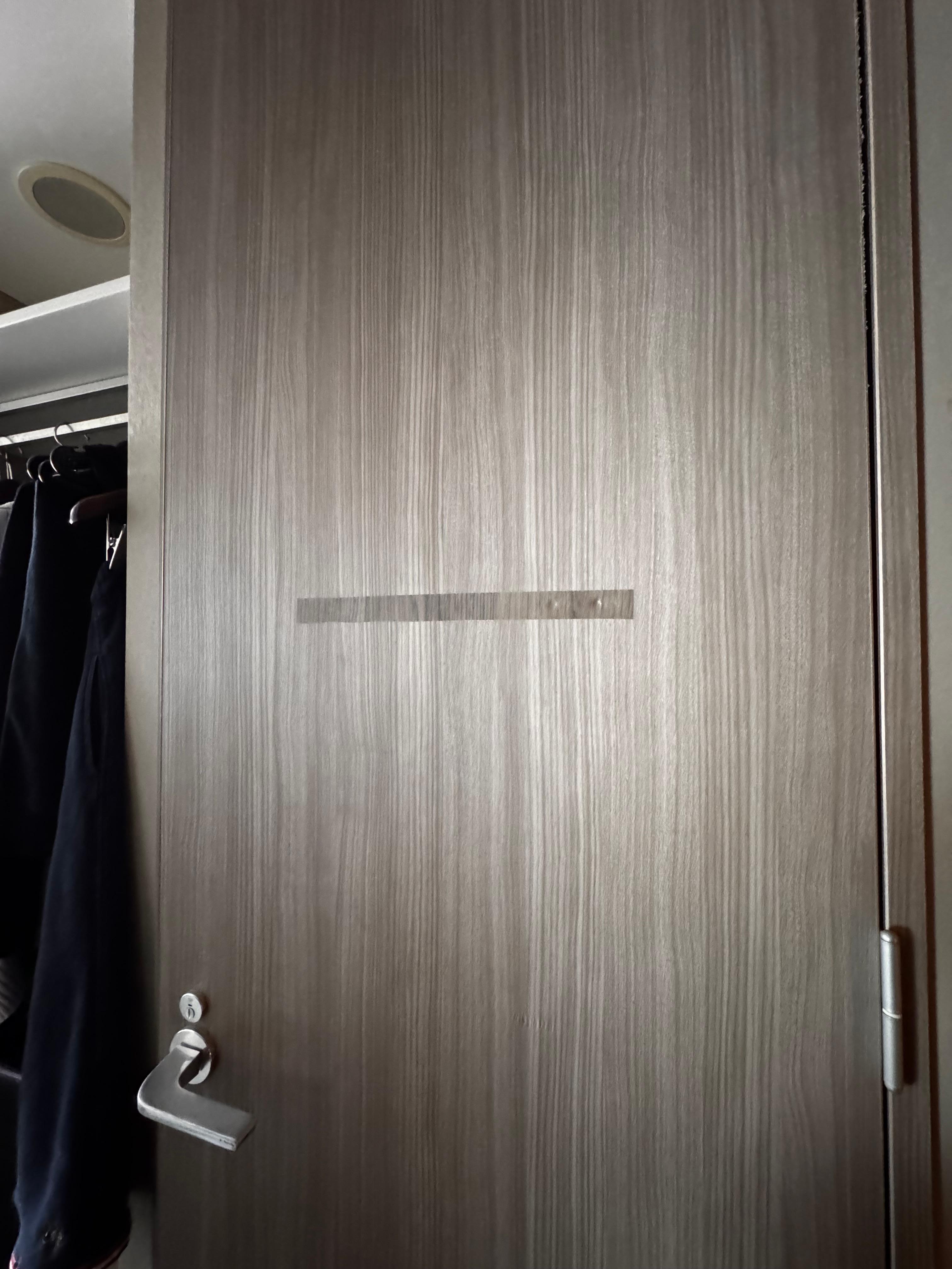 Damaged door finish pasted over with a sticker