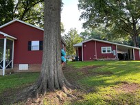 Backside of bungalow and outdoor screened in patio