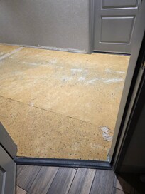 Holes in the carpet padding outside my door