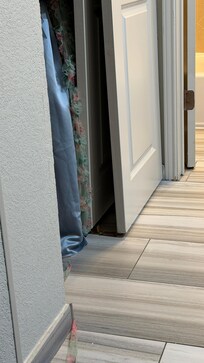 This is a door that is supposed to be on a track. The door does not move, its broken and someone just left it on the ground.