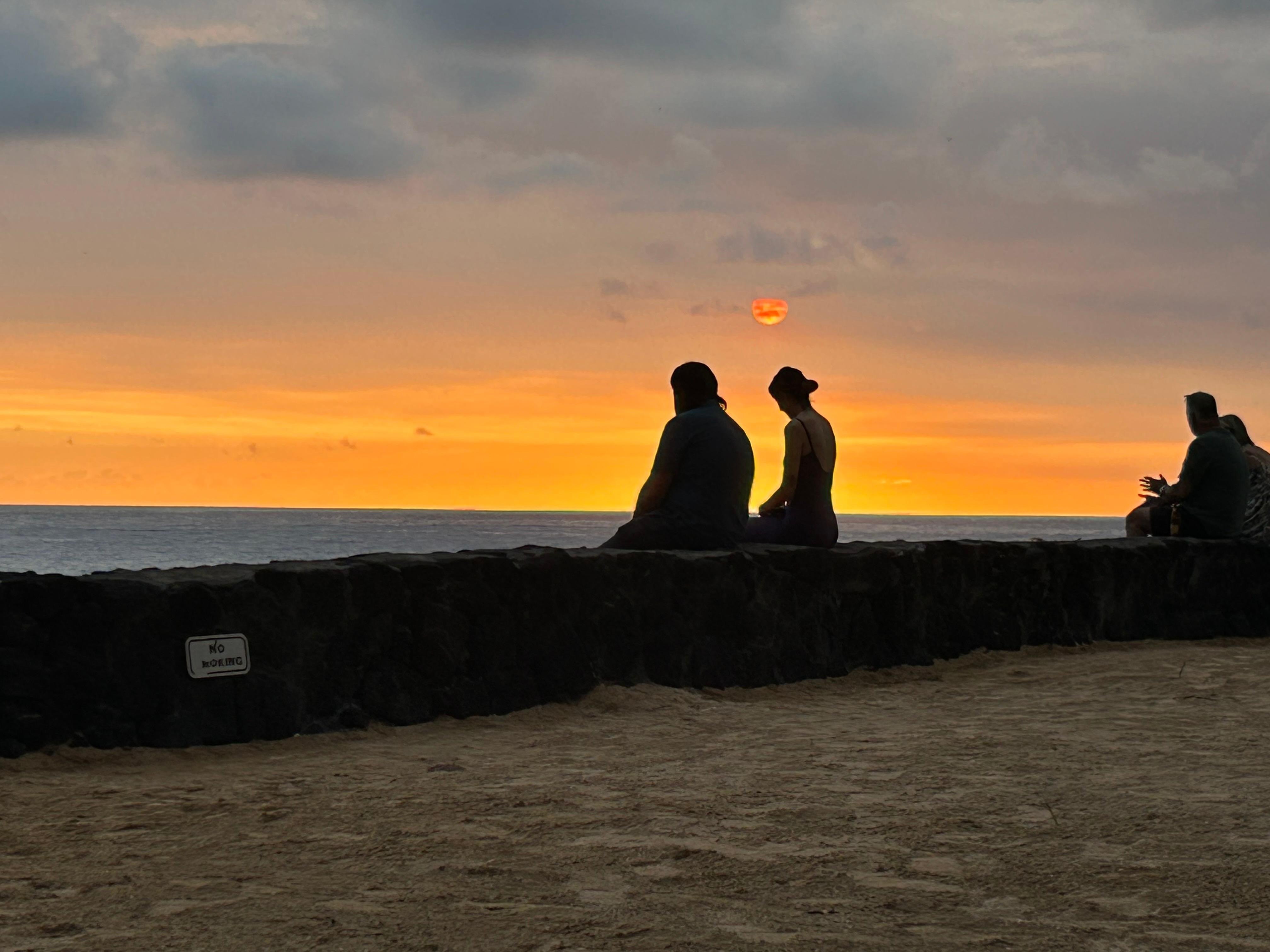 A photo a stranger took of us our first night there looking out at the ocean
