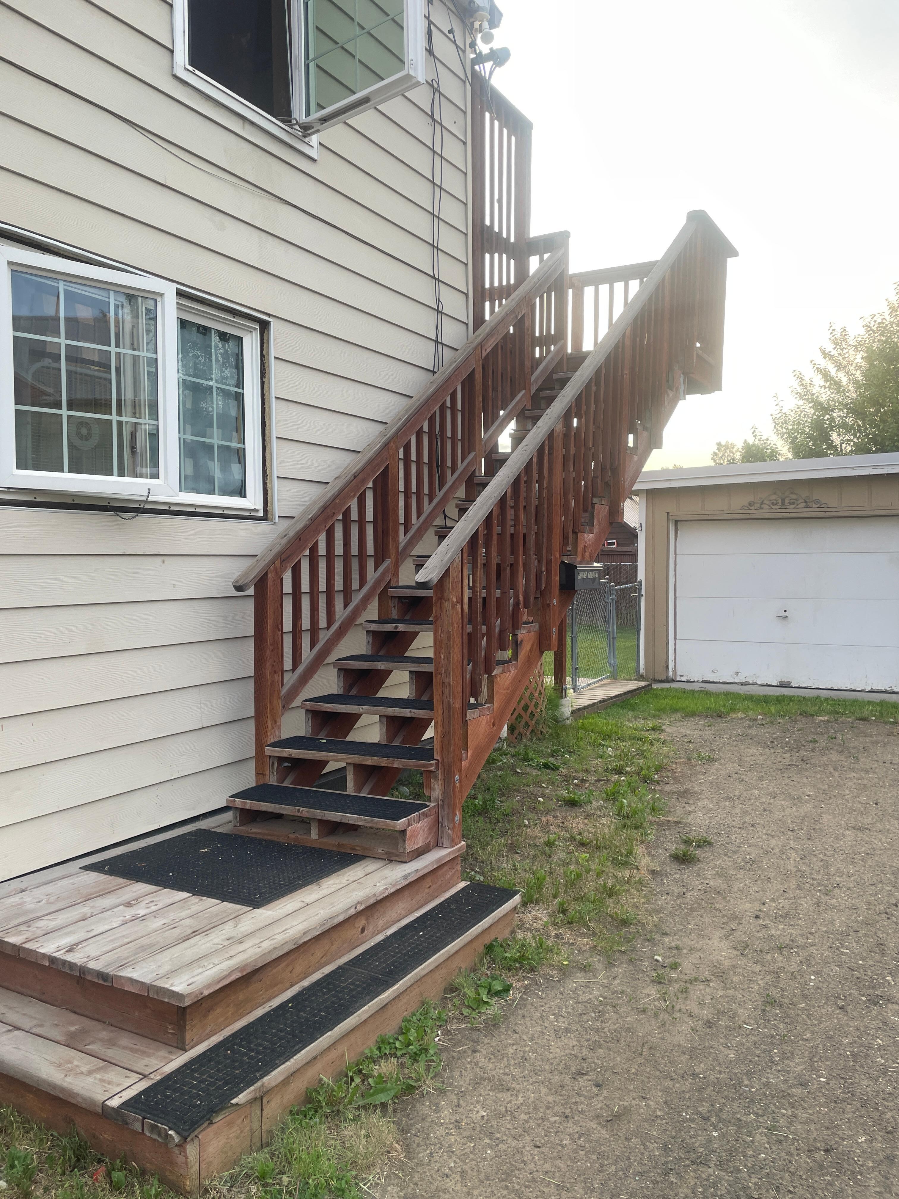 stairs leading to 2nd floor unit. no mention of a unit number visible here. 