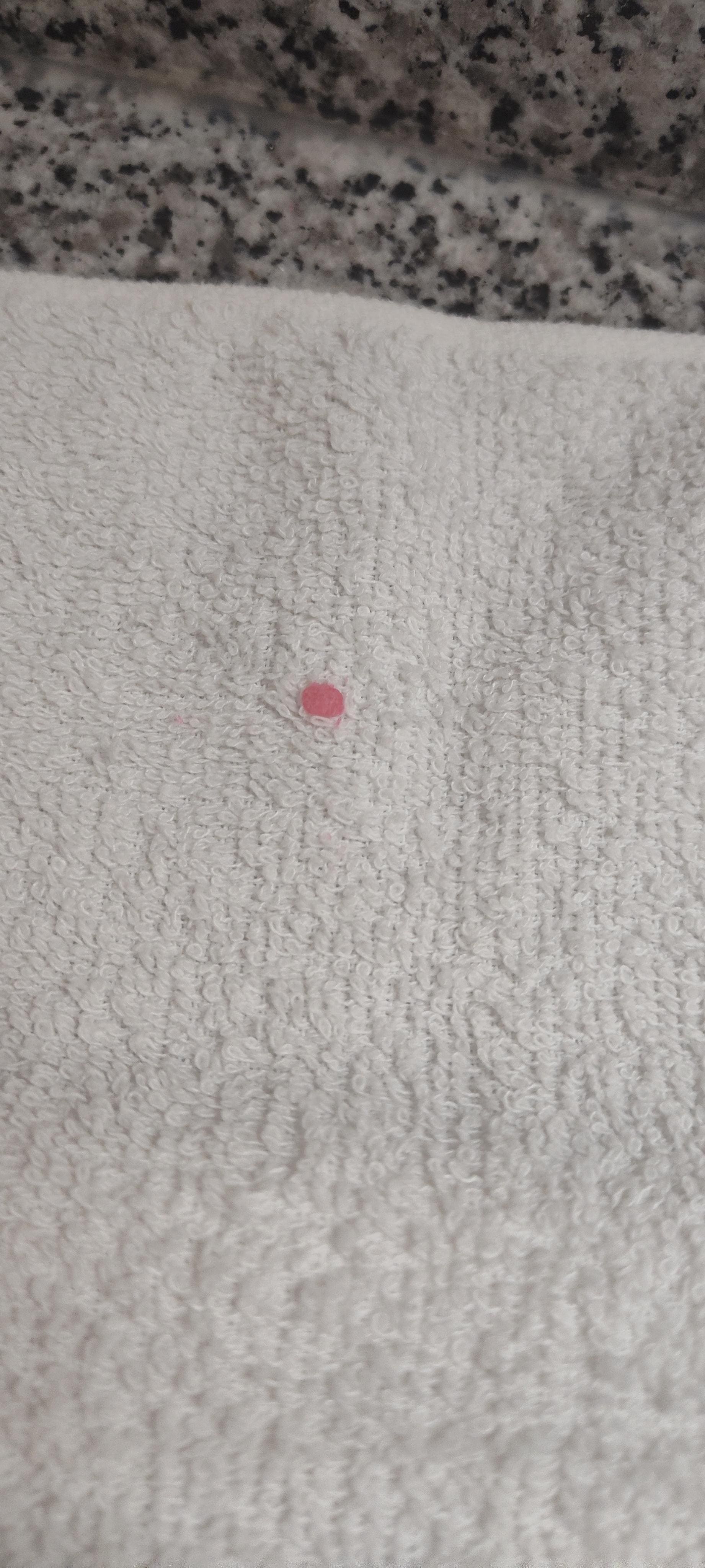 Pink substance on hand towel