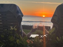 Enjoying the sunset with a glass of wine.