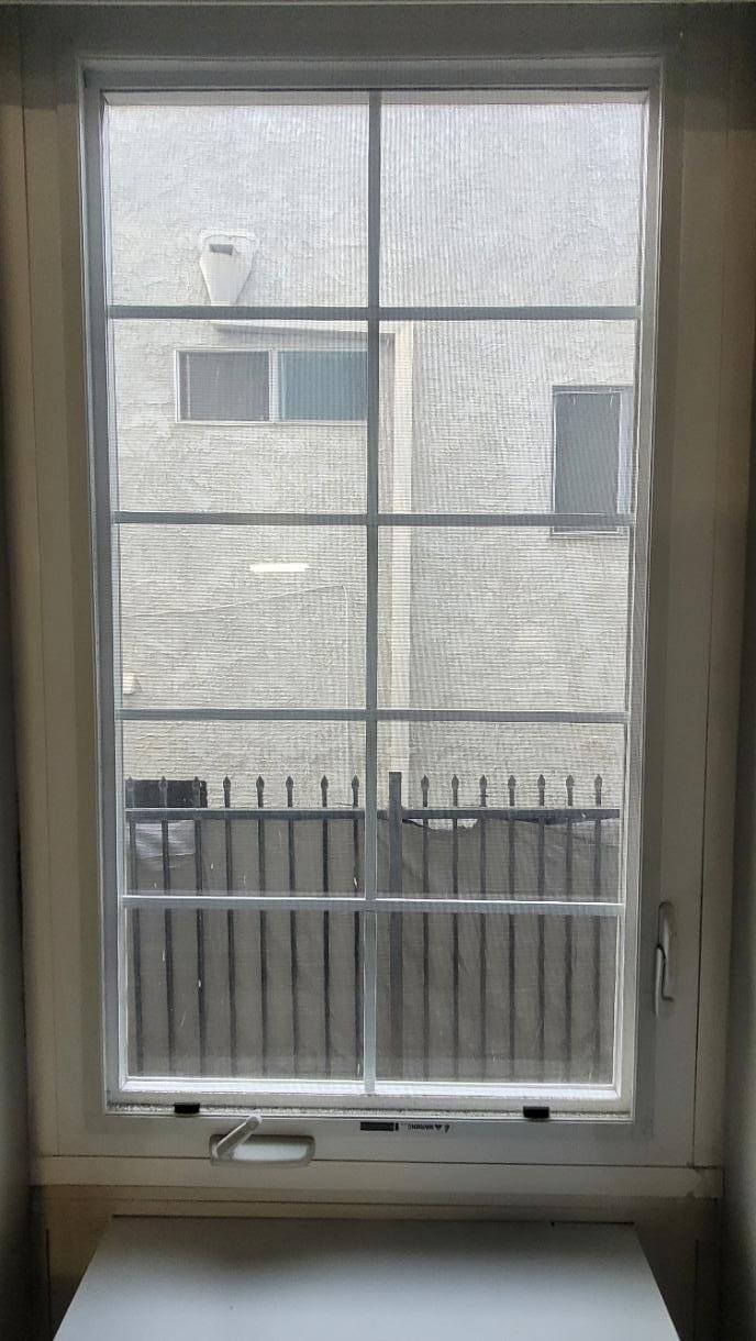 The "view" from room 201: an unpaved alley and the building between the hotel and the street.