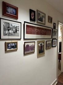 Beautiful photos in entry hall of king/ bath and queen/bath wing of apartment