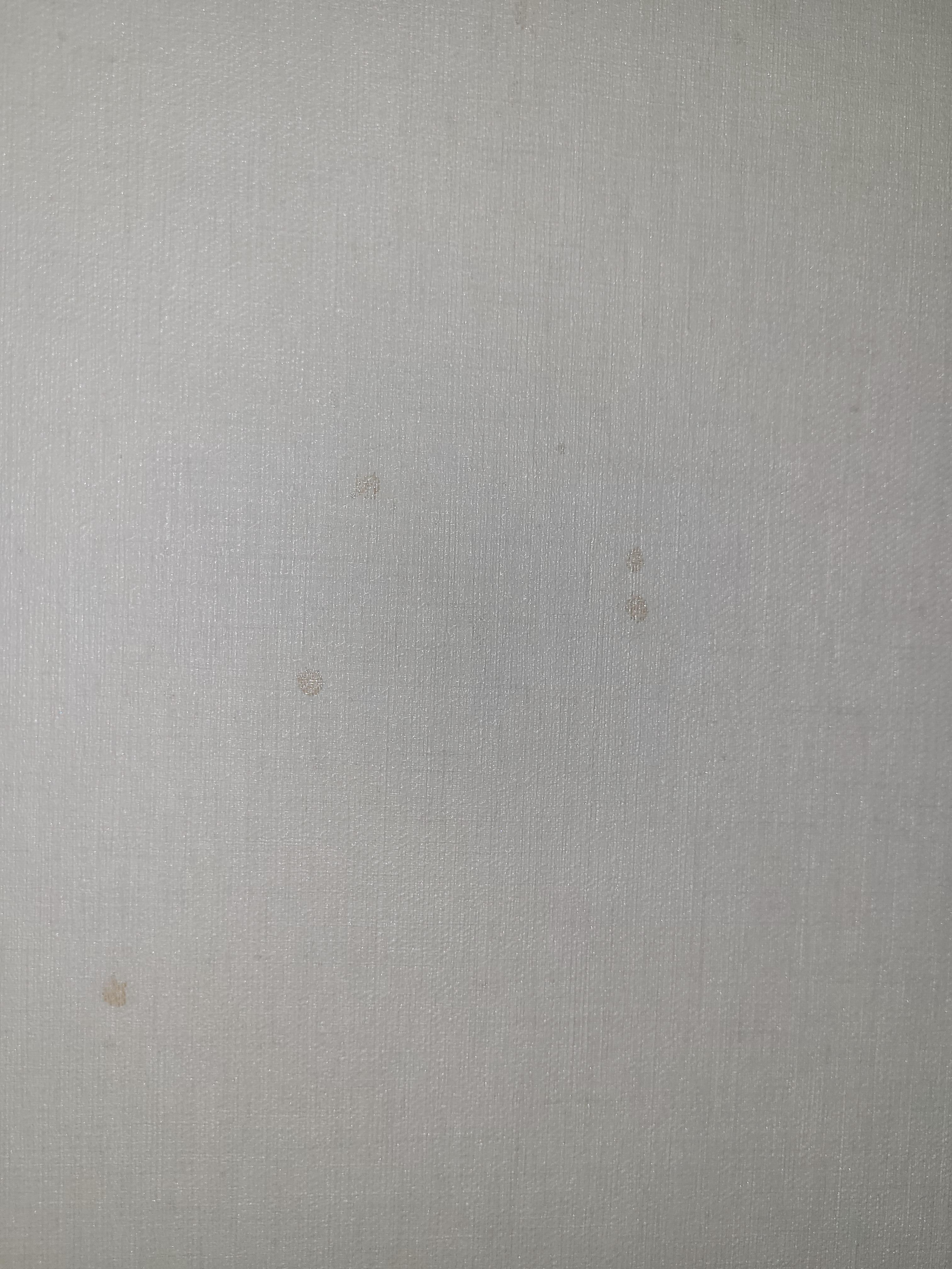 A bunch of red stains on the wall around the tv