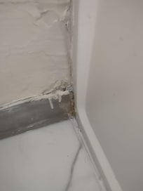 Patched drywall, where roaches entered the room.
