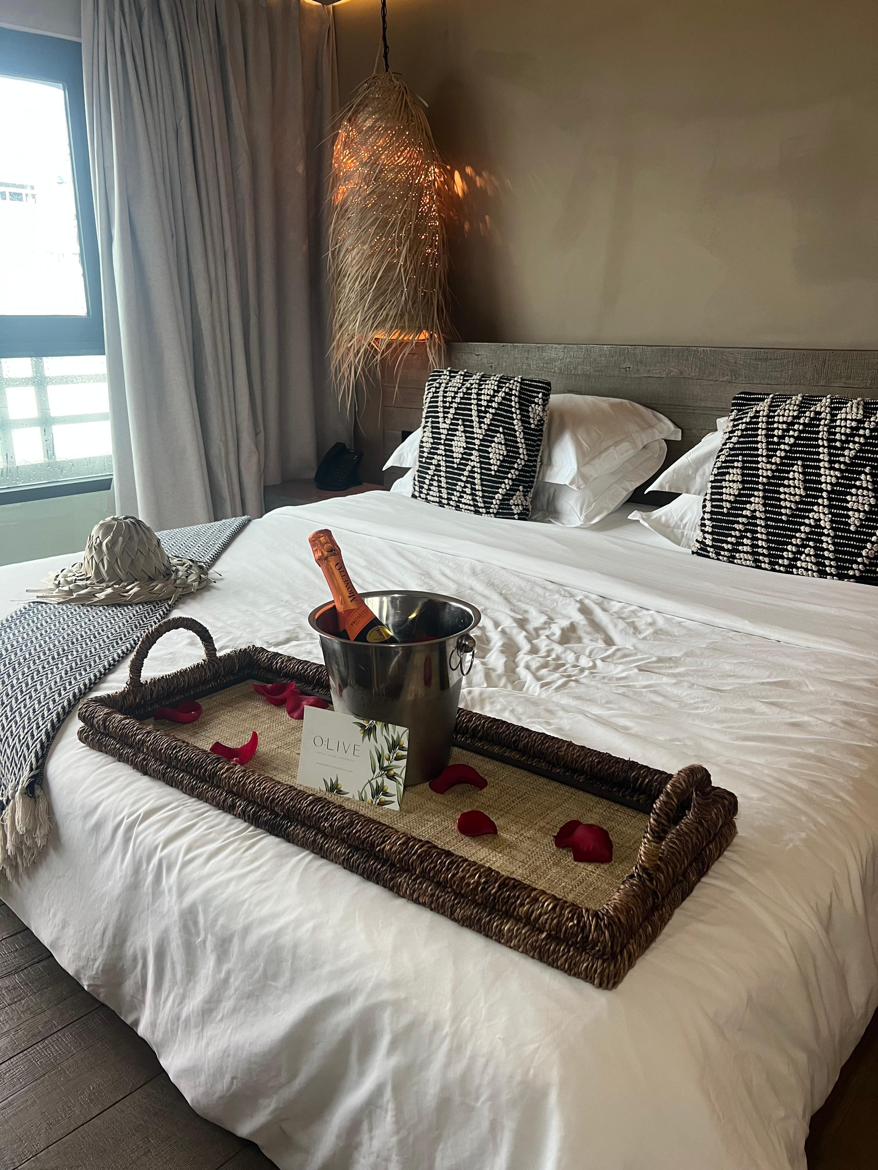 A complimentary bottle of champagne with rose pedals 