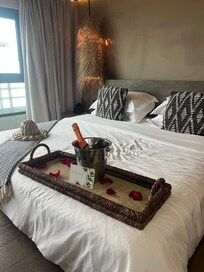 A complimentary bottle of champagne with rose pedals