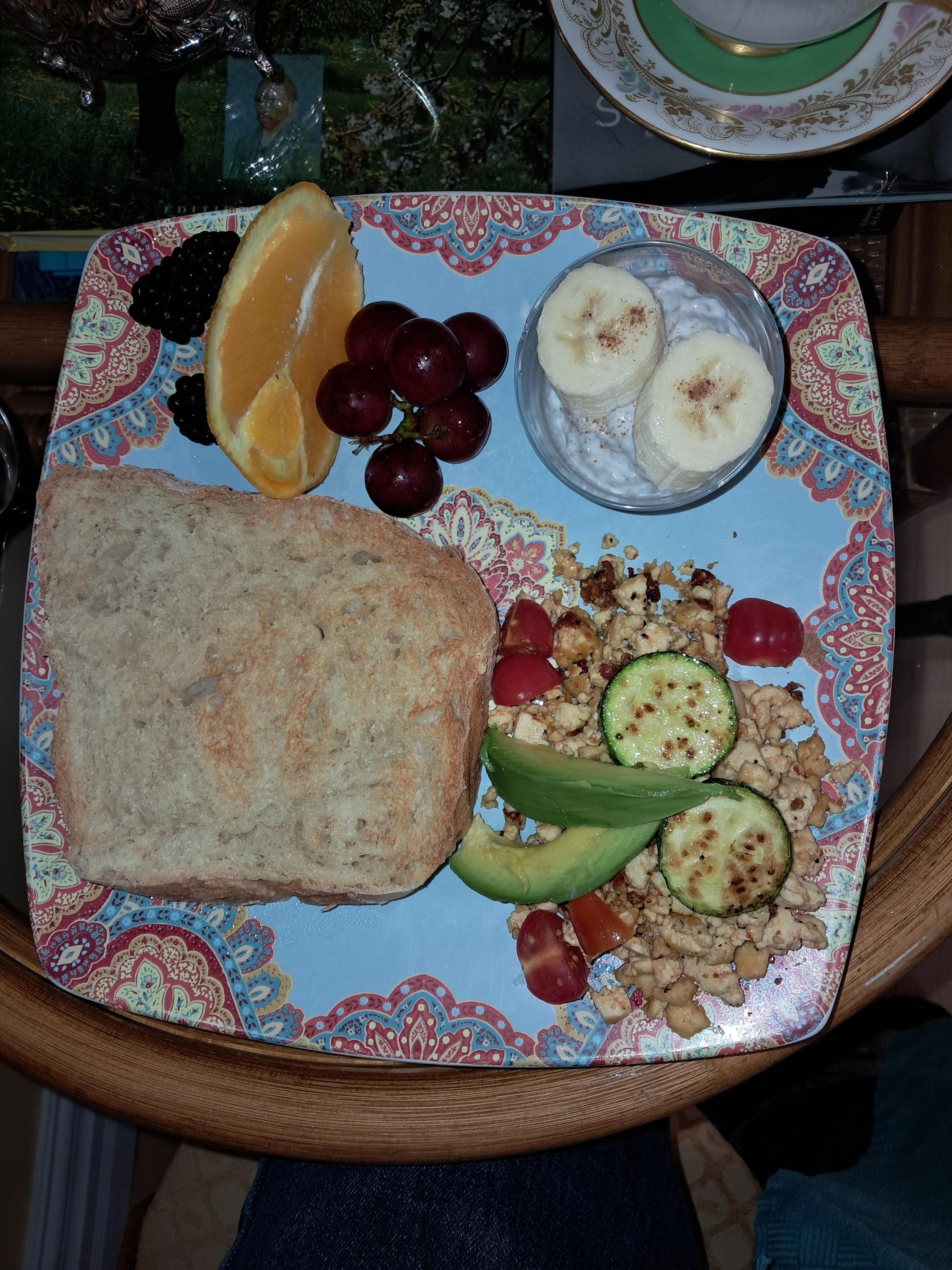 Tofu scramble, Chia vanilla pudding with a touch of cinnamon and banana, fresh fruit, artisan baked bread toast.