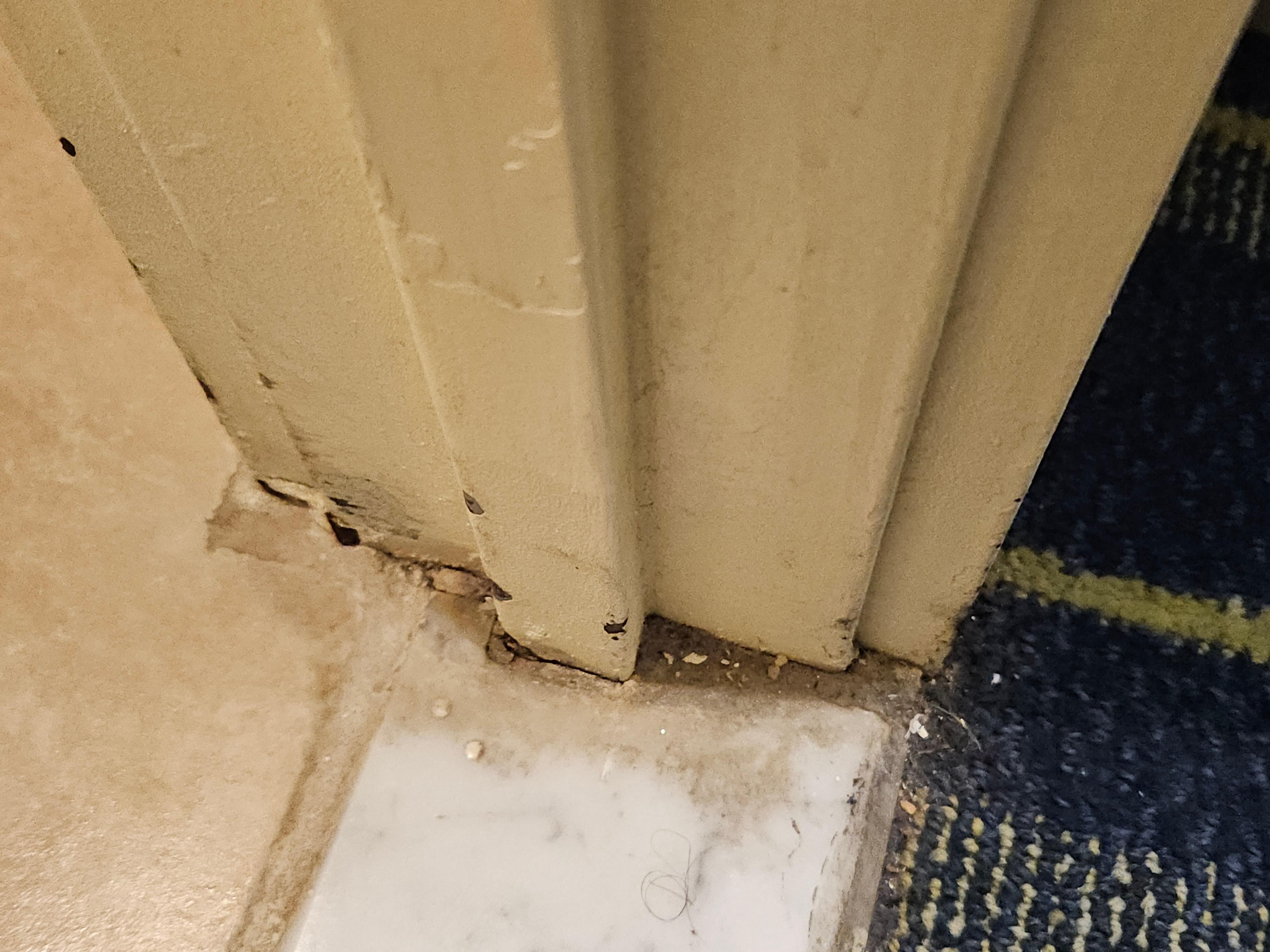 Dirt on the floor of the doorway to the bathroom. 
