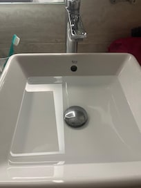 Not draining sink; bad sewage smell near the toilet. Towels really old and stained. Dusty room (lamps, all surfaces.