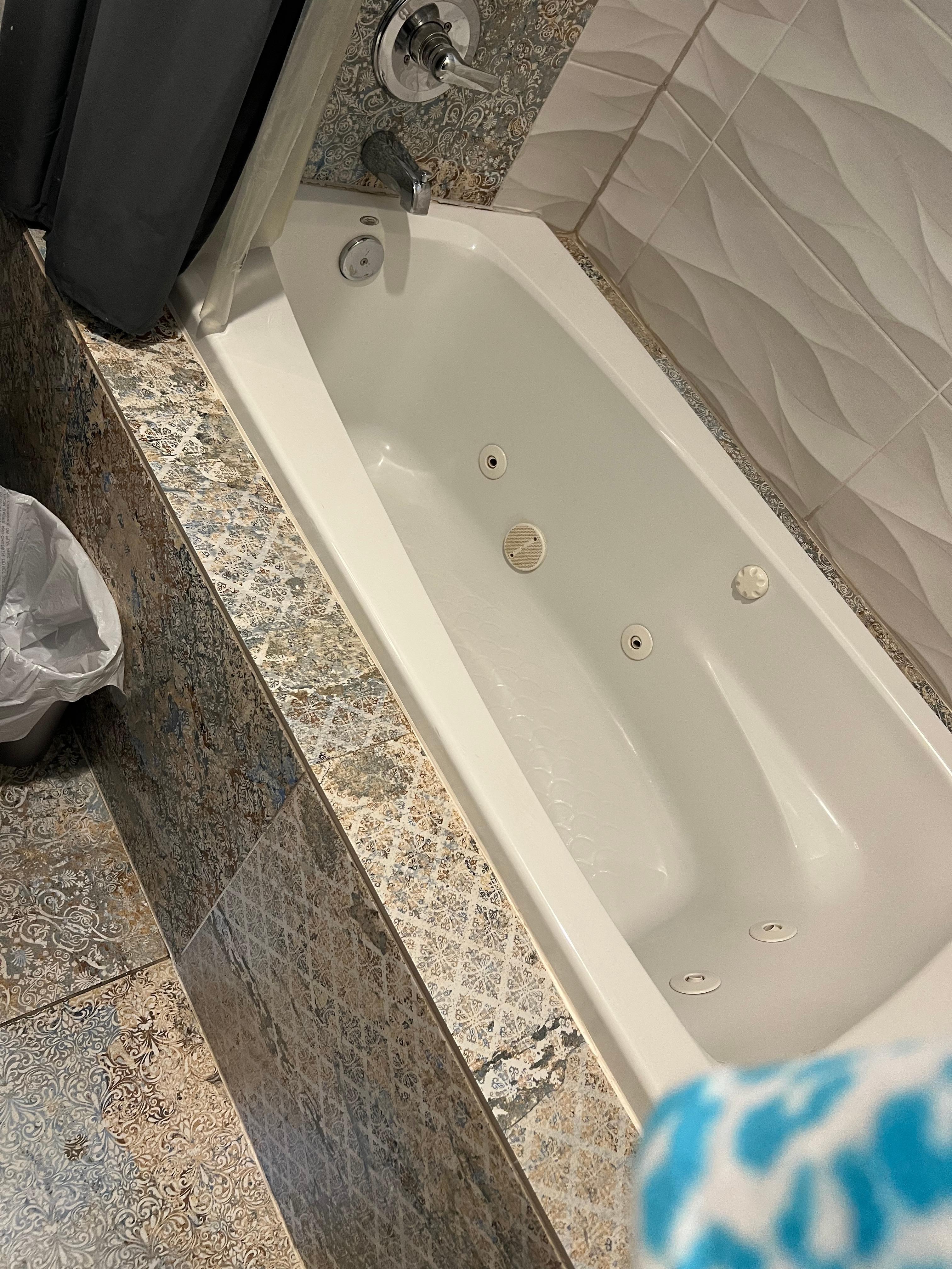 Tub difficult to get into. Good water pressure. Shower curtain moves too much.