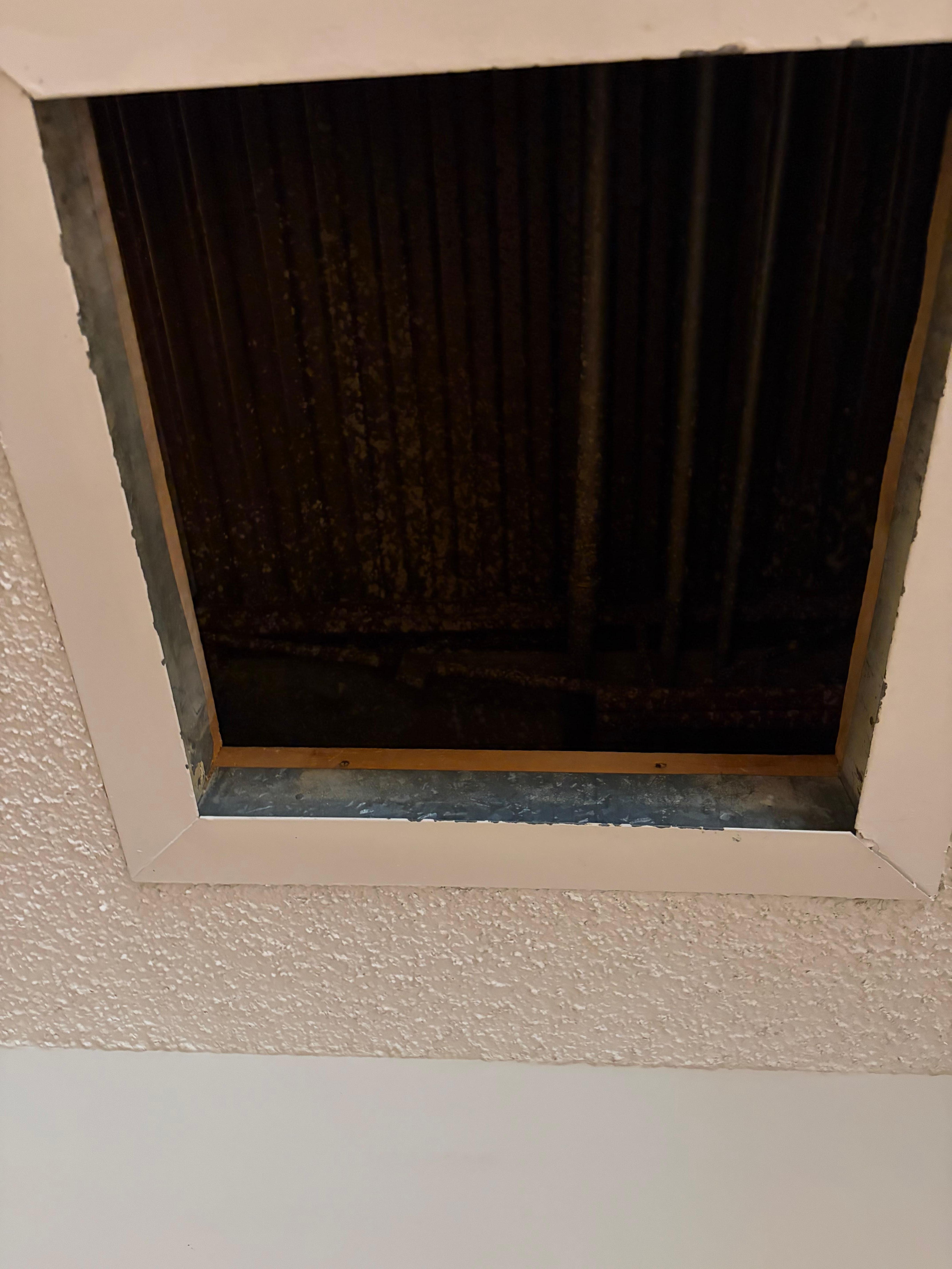 Hole with pipes showing in the ceiling. 