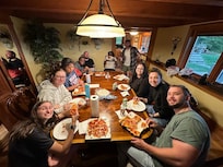 Finally sitting to eat our cooked pizzas!