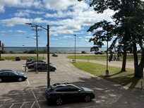 Across from Lake Superior. Busy roadway at times hard to cross if walking to the trail.