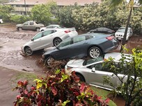 Our rental car on top of 2 others in condo parking lot
