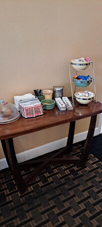 Table in front table with fresh cookies and condiments for coffee and tea.