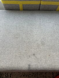 Sofa in the room, stained