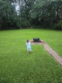Fully fenced backyard (also bubbles and other outside toys available.) There was a BBQ, and corn hole and such beautiful porch swings and chairs too.