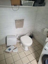 Utility room with washing machine.