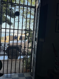 Gated front door we left padlocked but open for views and breezes