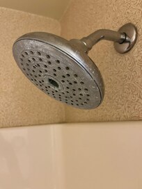 Hard water stain buildup on all fixtures.