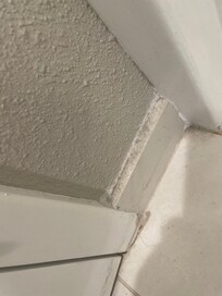 Dirty baseboard one of several by and in bathroom.