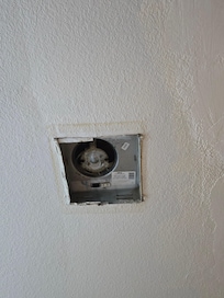 Hole where bathroom fan should have been.