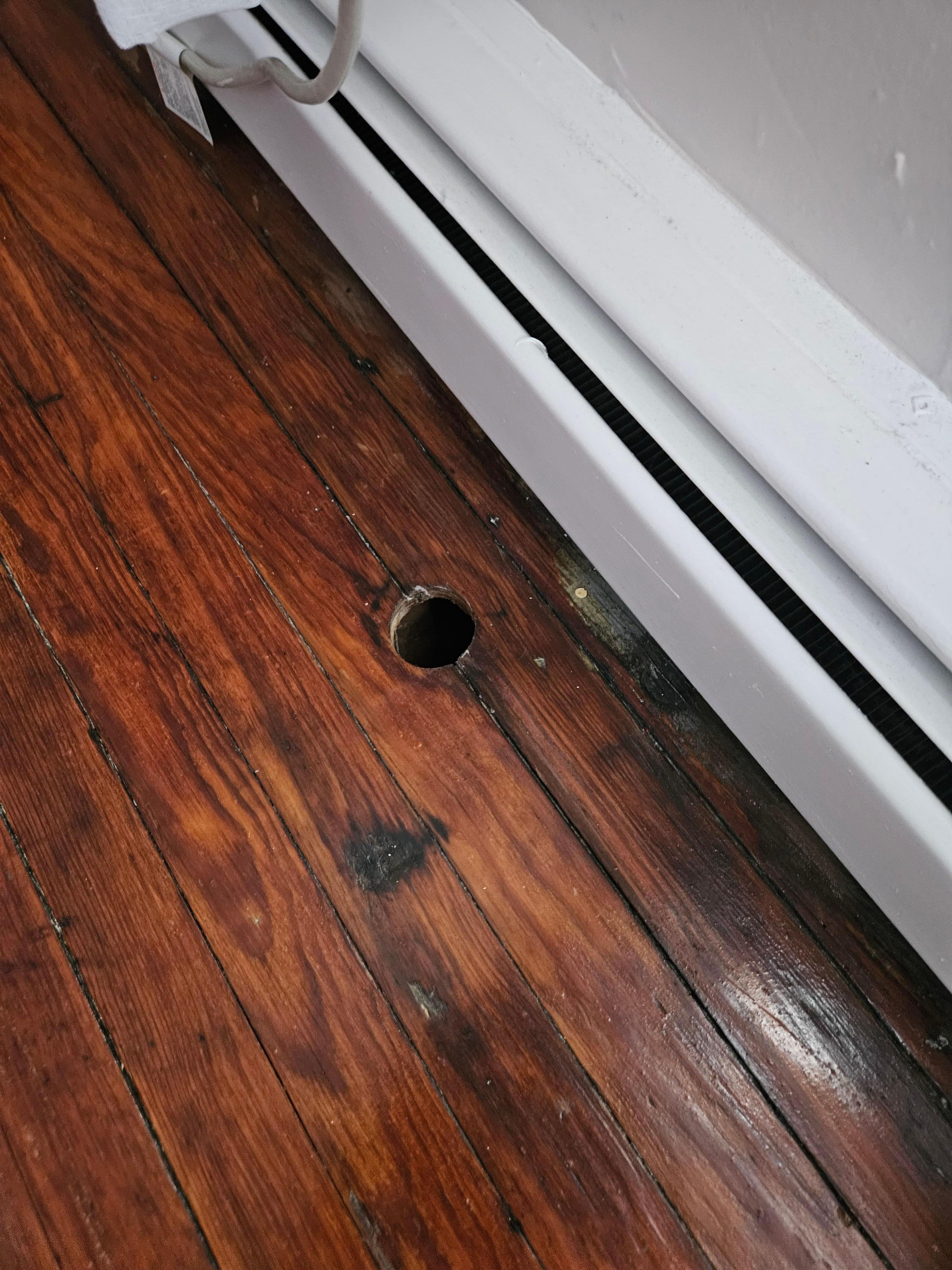 Hole in the floor in one of the rooms. There were holes in the floor of all the rooms upstairs