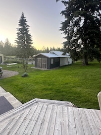 View from the deck of the Farmhouse and Log Cabin…the building is Jean’s home and garden.