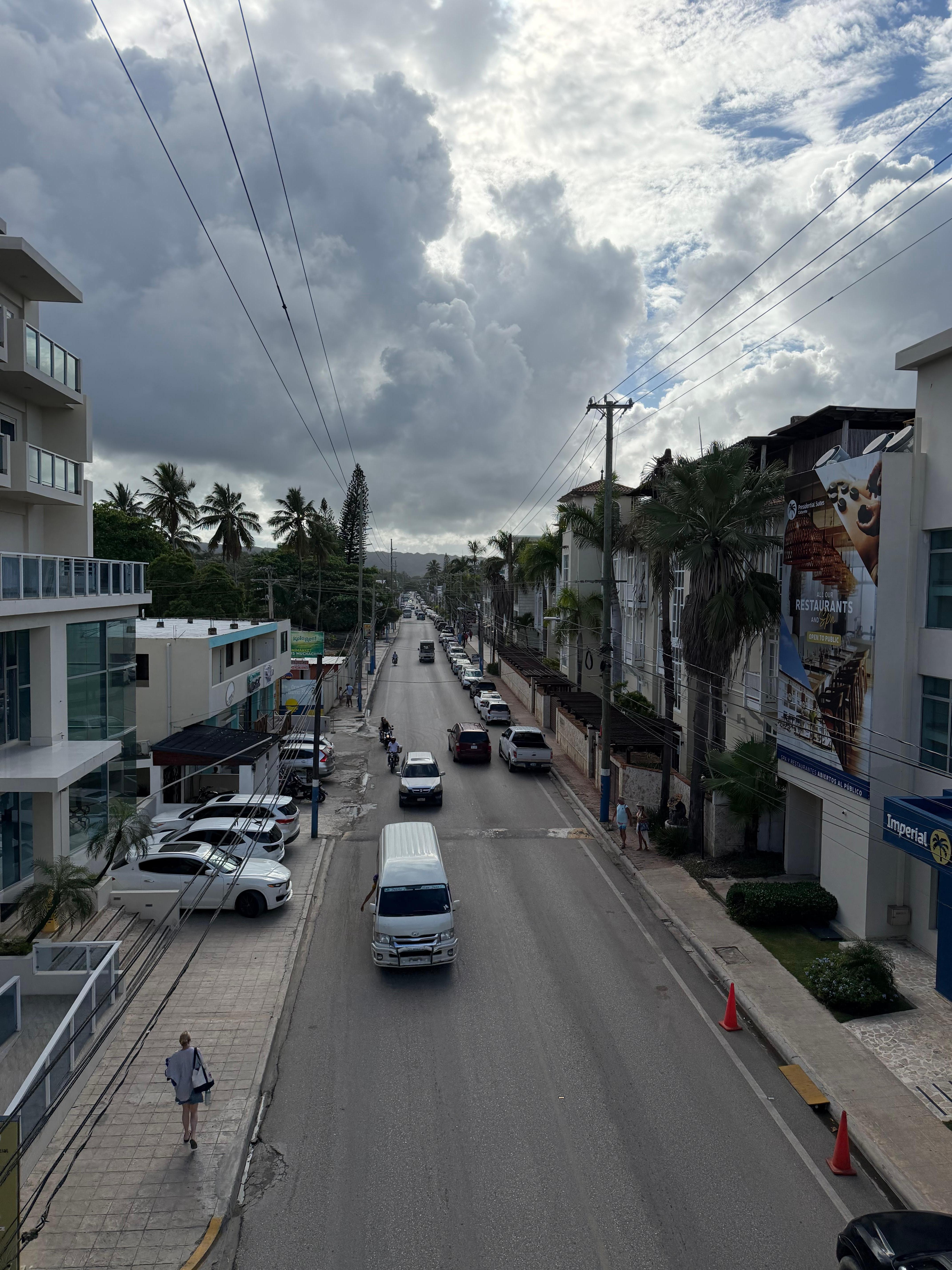 Main Street. Hotel has buildings on both sides of the road and there is a ped bridge over it