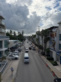 Main Street. Hotel has buildings on both sides of the road and there is a ped bridge over it