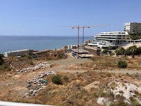 The view is being changed by development of buildings that obstruct the coastline.