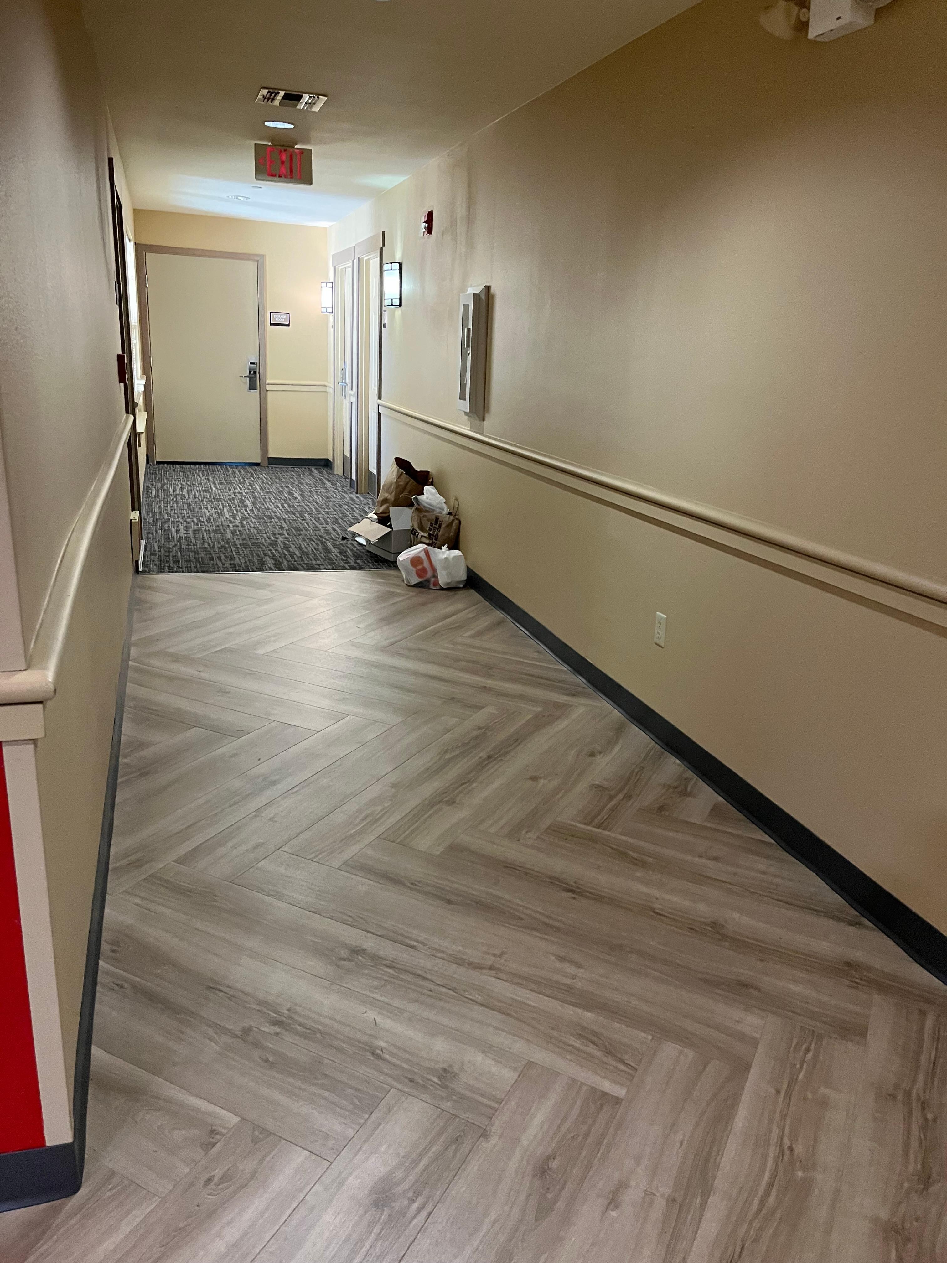 Trash in the hall uncollected by staff. 