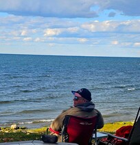 Hubby relaxing by the lake off the back of the property