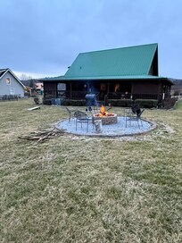Nice big back yard with fire pit, grill, corn hole.