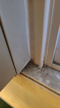 Thick black dirt on window sills.