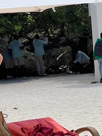 Waiters at the beach hiding instead of taking orders