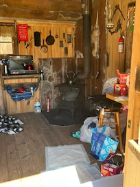 Inside Cabin wood burning store , Coleman stove
