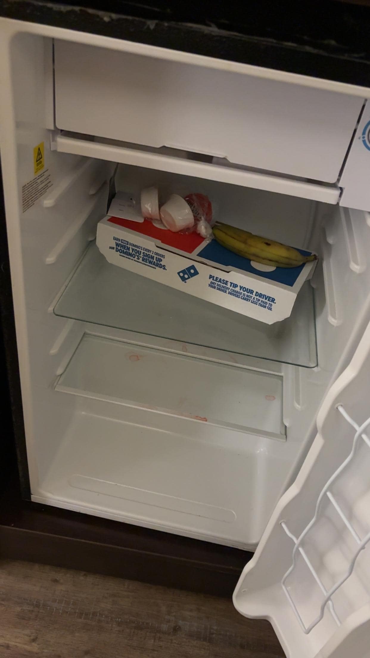 this was pizza and an old key card along with juice stains that was found in the refrigerator