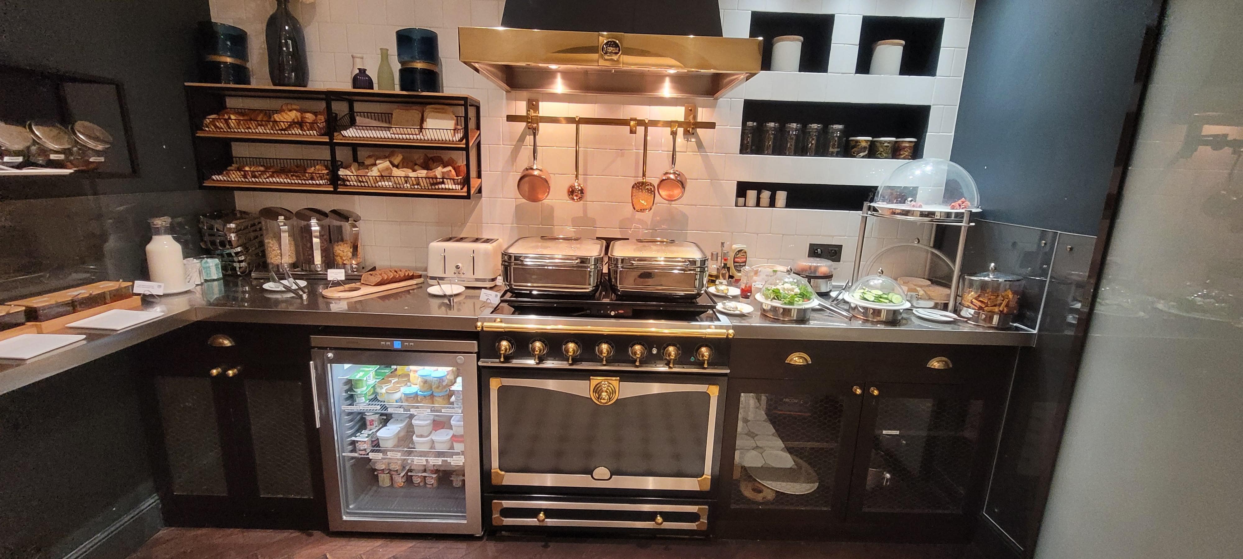 Scrambled eggs, bacon, sausage, cooked veggies, cheese and more cheese, cucumbers,  tomatoes and more.