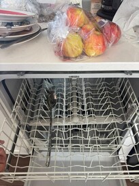Dishwasher not bolted to cabinet. Bottom rack would fall out when loading due to it not being bolted in.