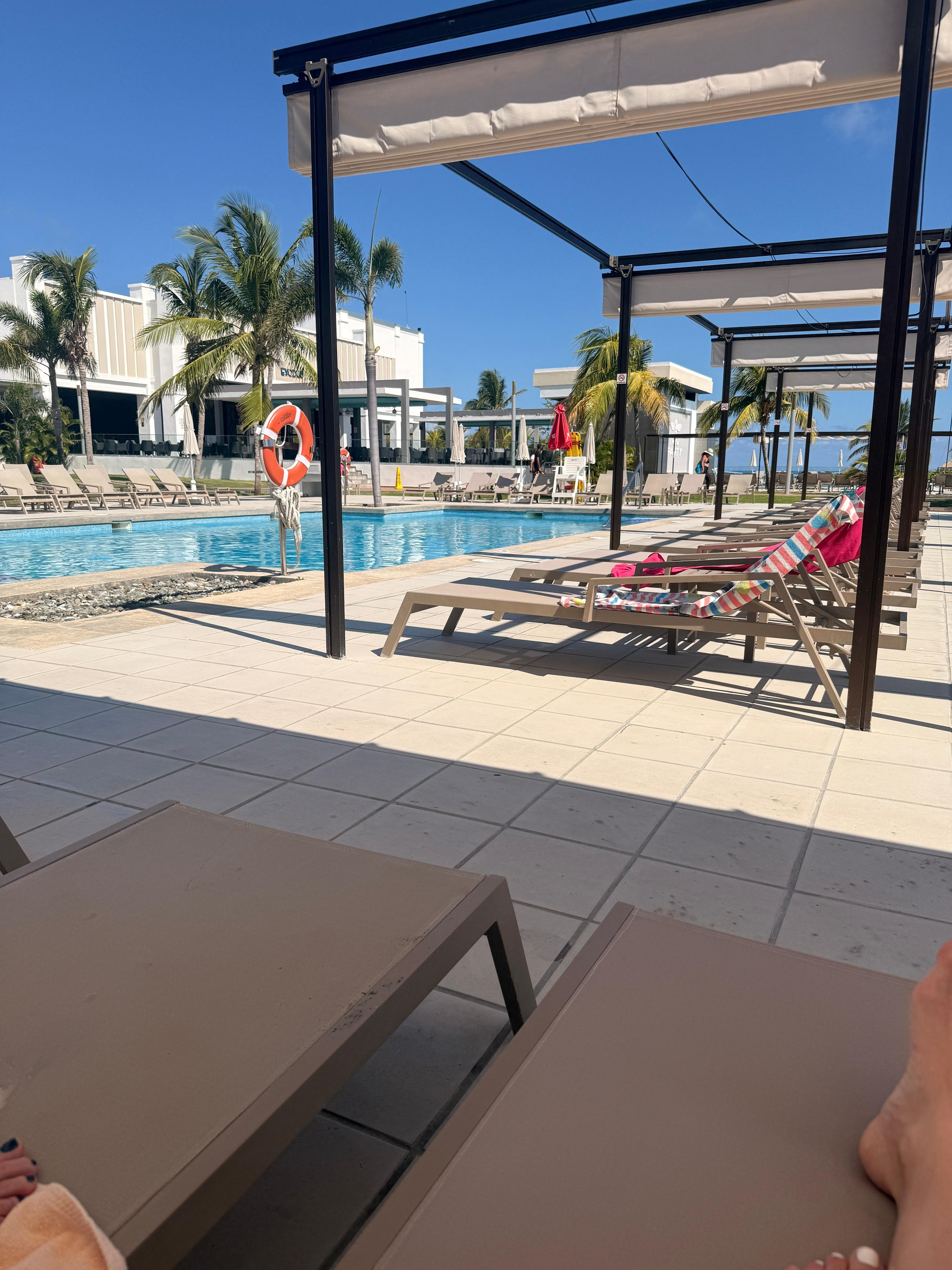 Poolside loungers with shade covers