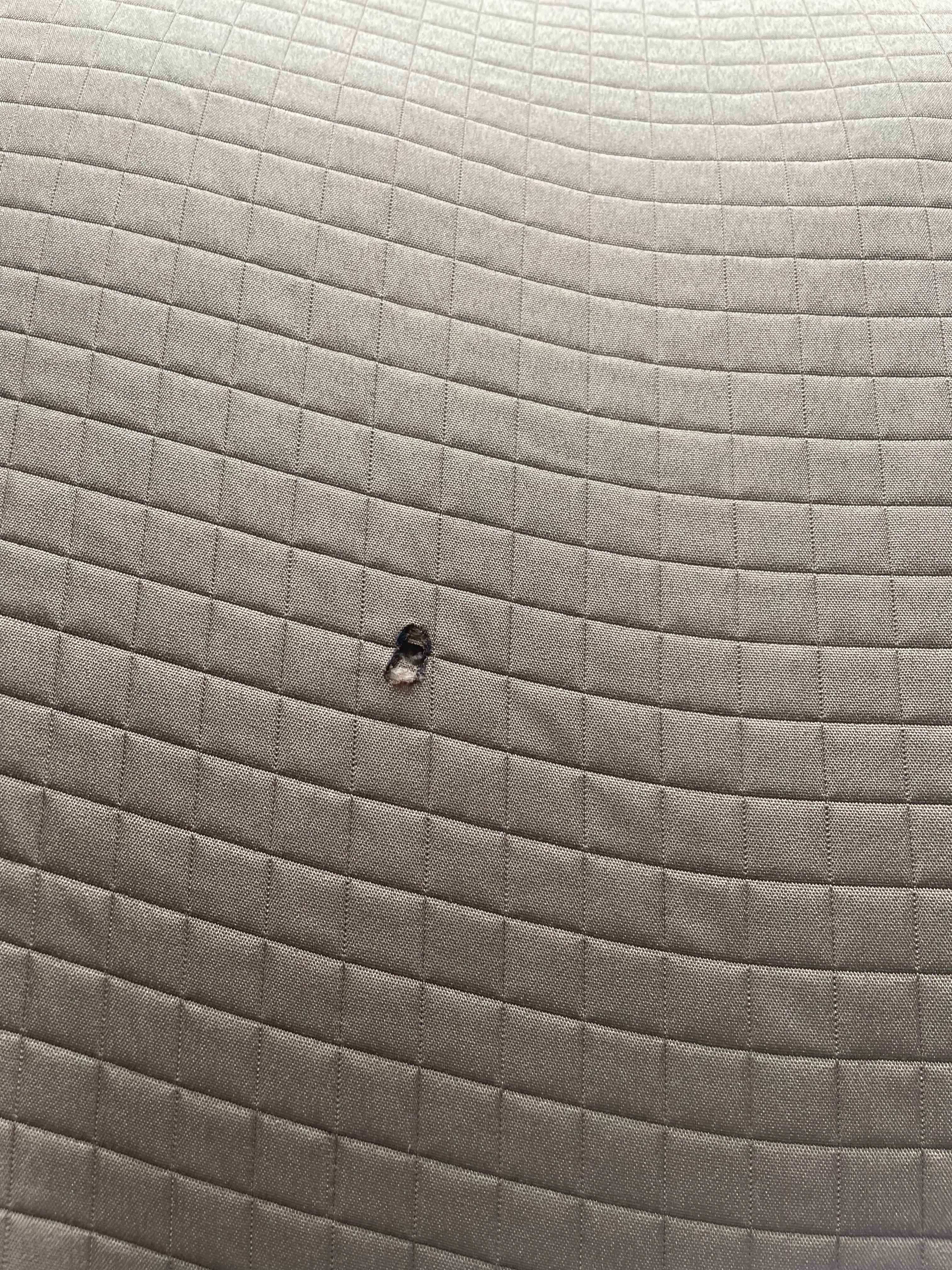 Cigarette hole in bedspread